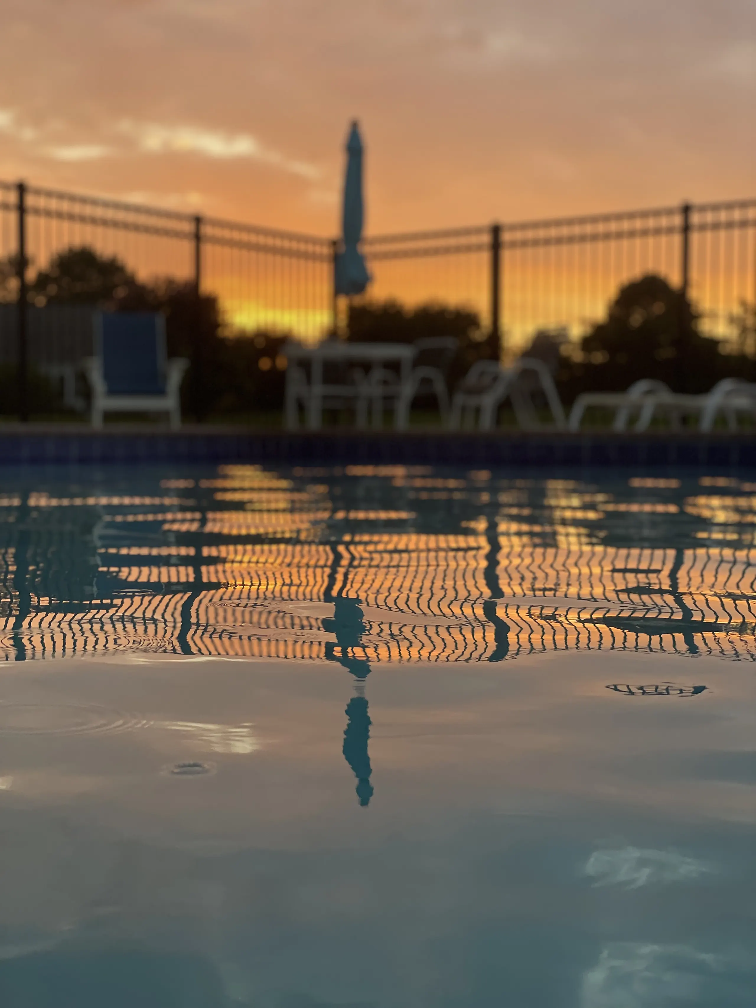 Chairs along the pool fence