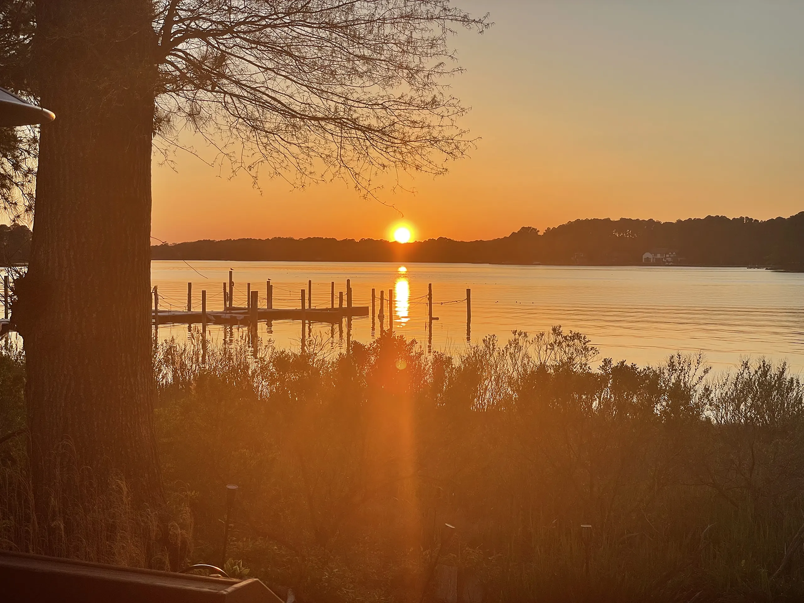 The sun setting behind the community dock